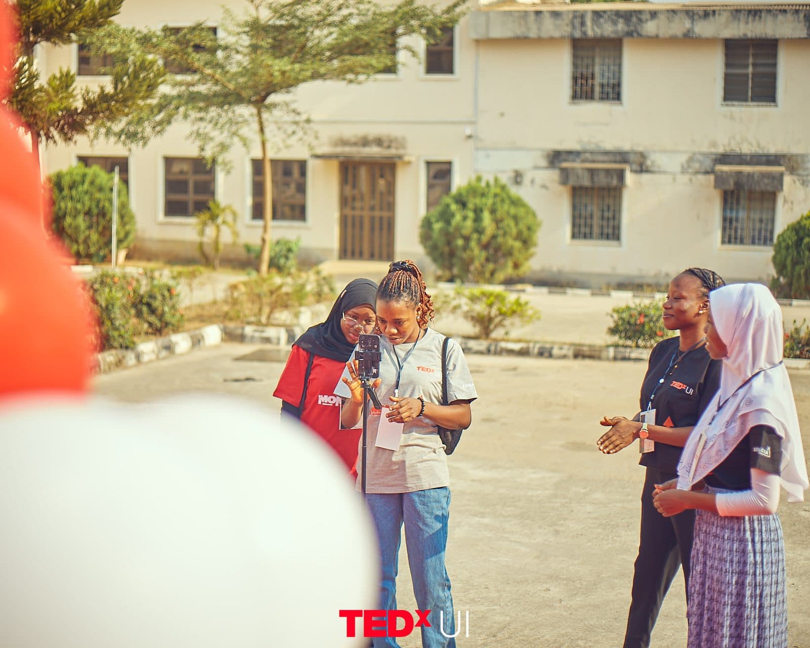 Attendees chatting in a group outside the venue.